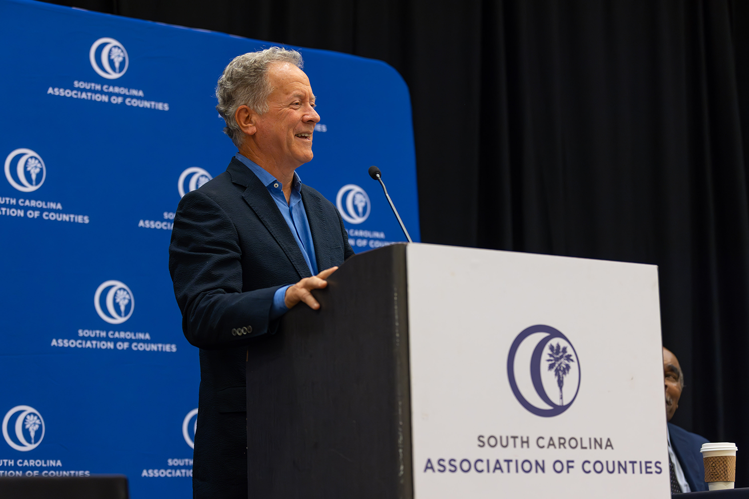 Former South Carolina Gov. David Beasley speaks at a podium during the 2024 SCAC Annual Conference.