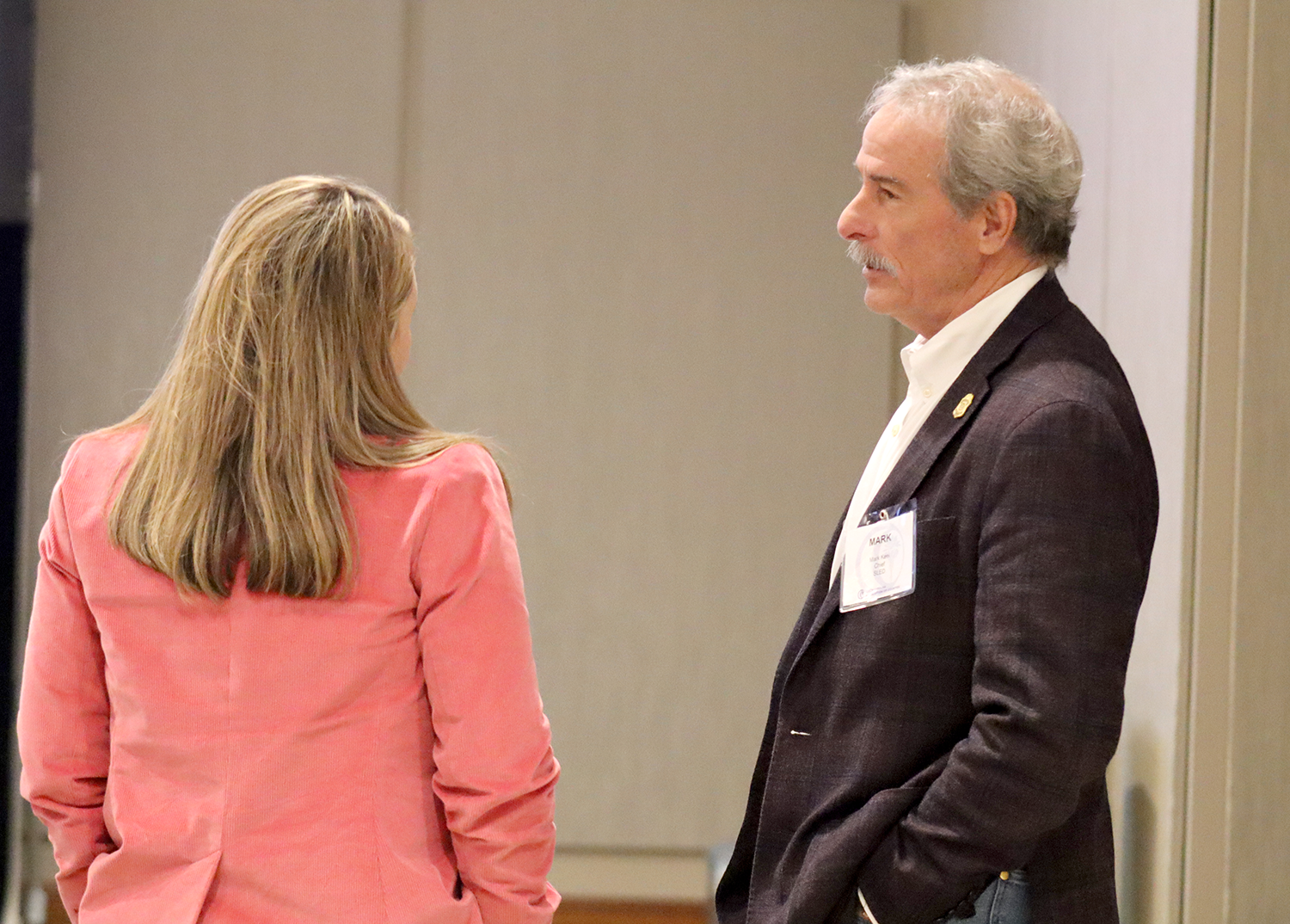 A man and a woman speak to each other during the 2024 Local Government Attorneys' Institute.