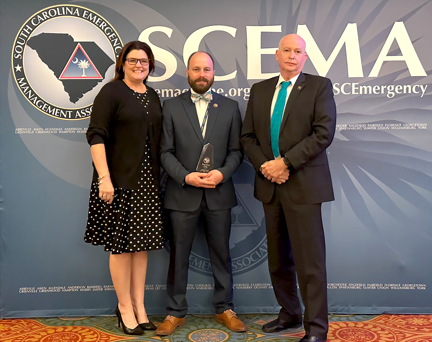 Brandon Ellis (center) accepts the Director of the Year award from the S.C. Emergency Management Association.