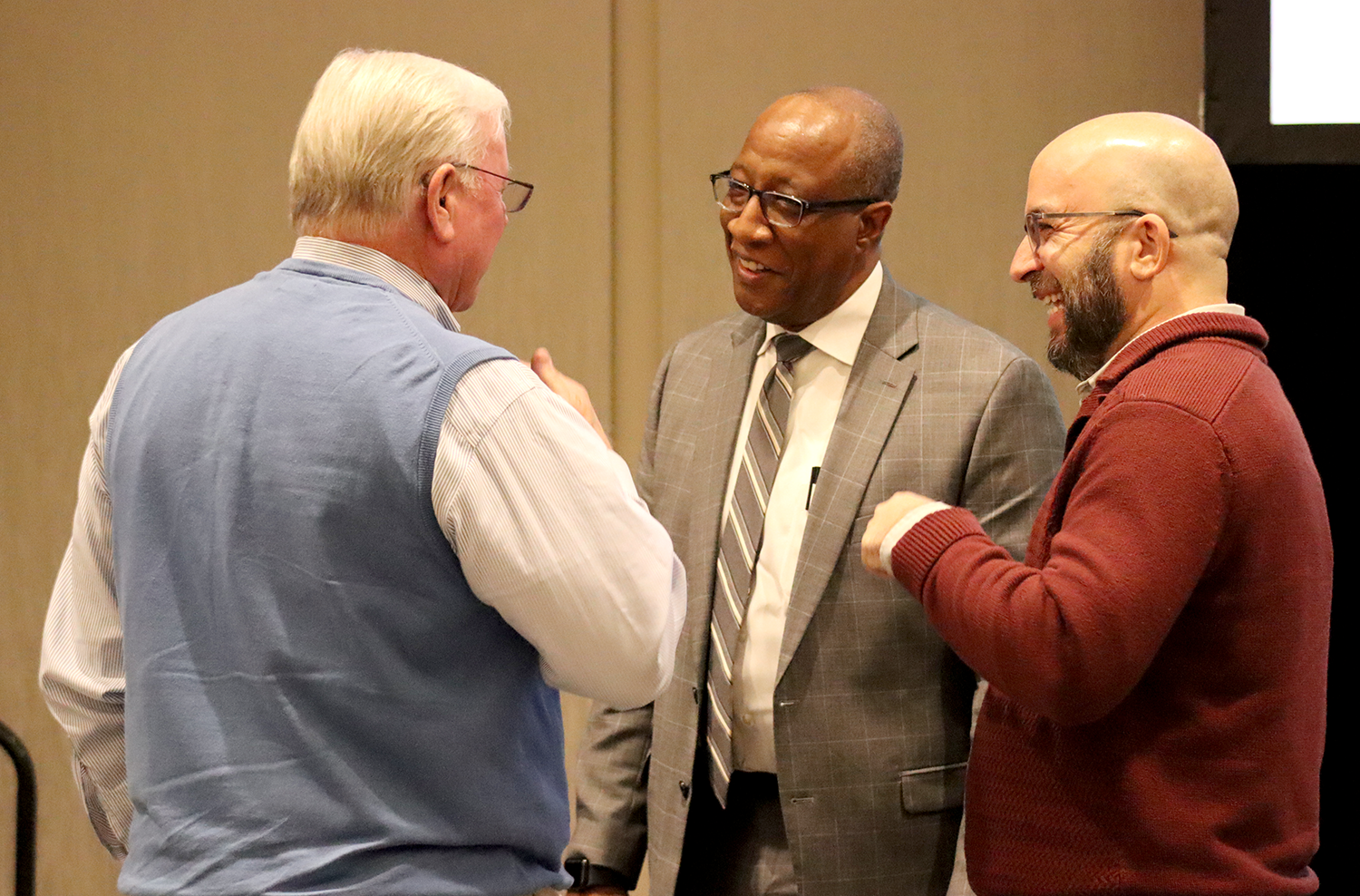 Three men talk with one another during the 2024 Local Government Attorneys' Institute.