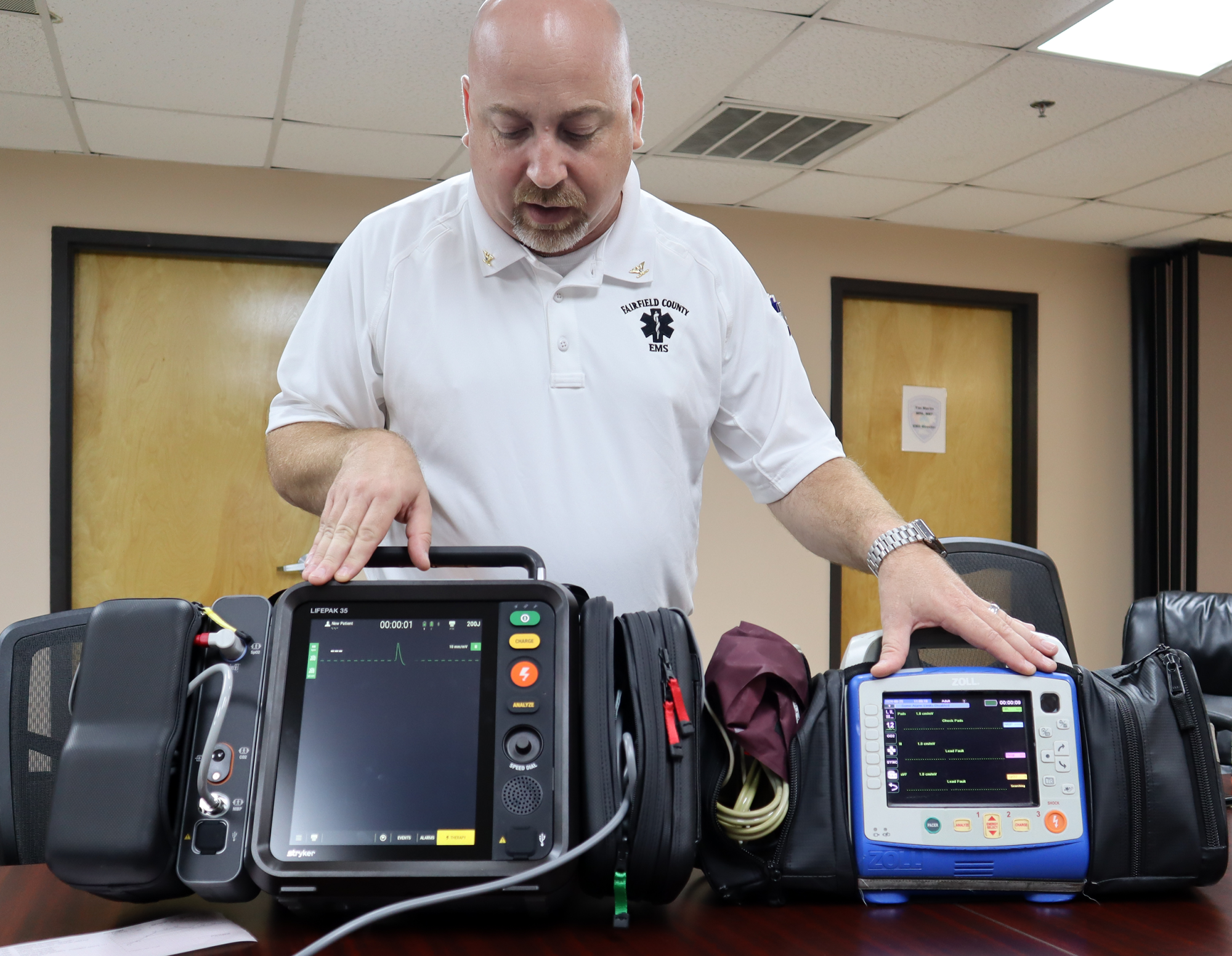 Fairfield County EMS Chief Tim Martin shows the difference between the new Stryker LifePak cardiac monitor and the older Zoll model.